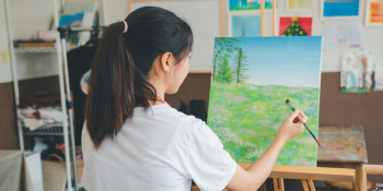girl doing art on an easle
