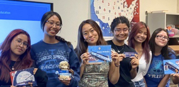 Group of kids in front of map