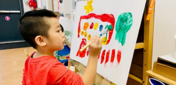 Boy painting on canvas