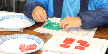 student with dominos learning math