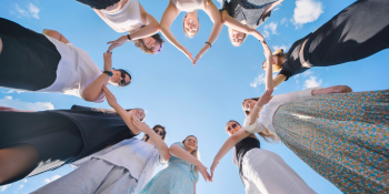 students with arms connected forming heart