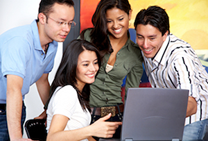 Teachers working and looking at laptop