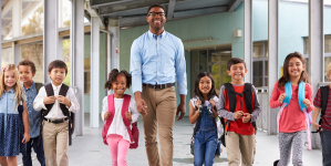 Image of a teacher working with a student in class