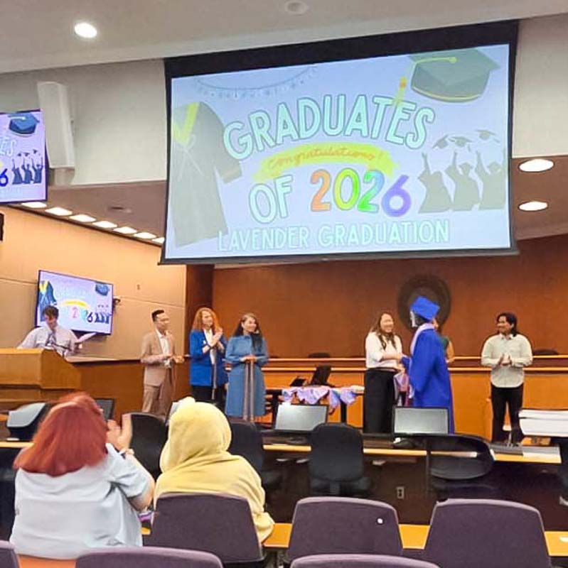 graduating student walking across stage and shaking hands