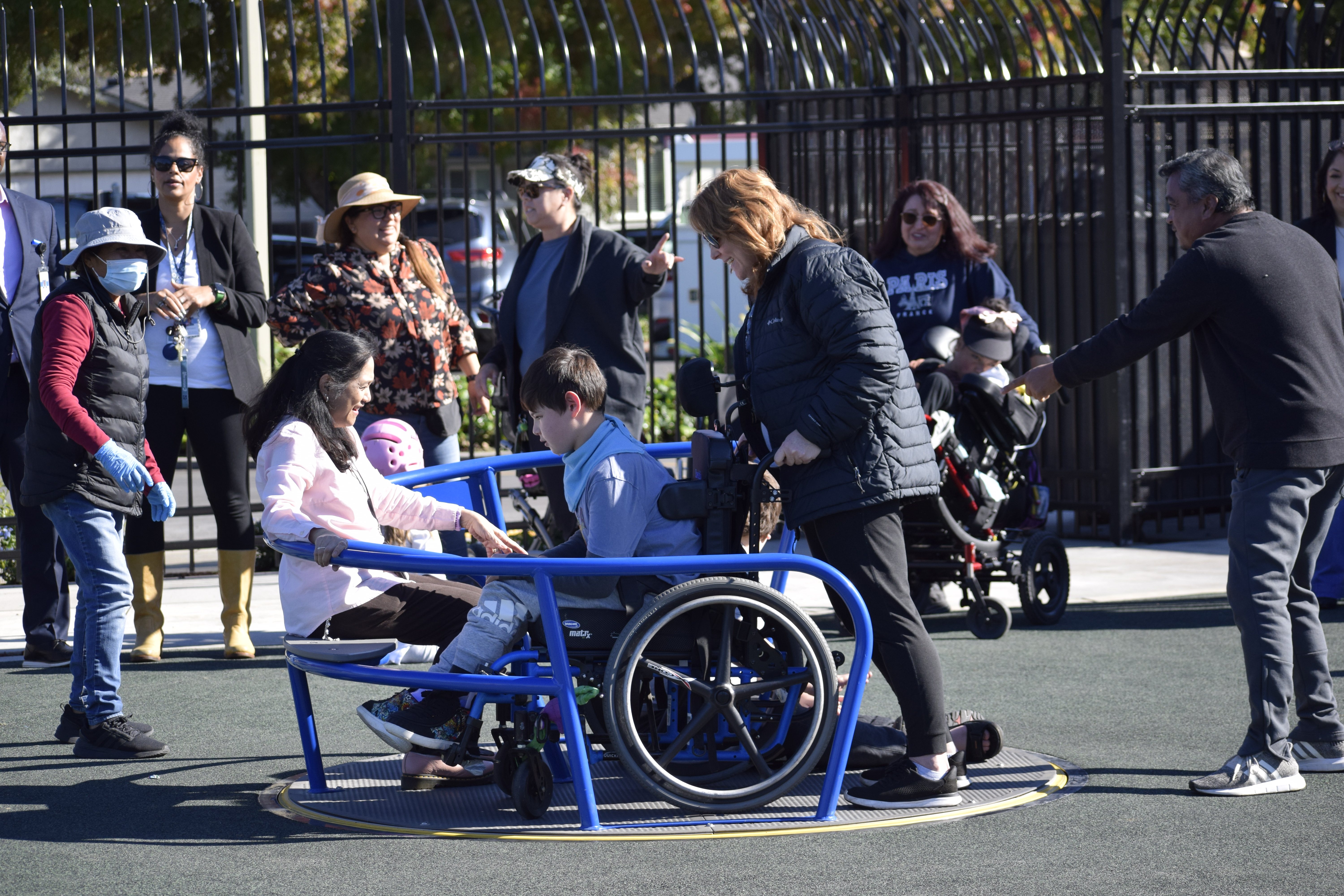 student in wheelchair on accessible merry-go-round