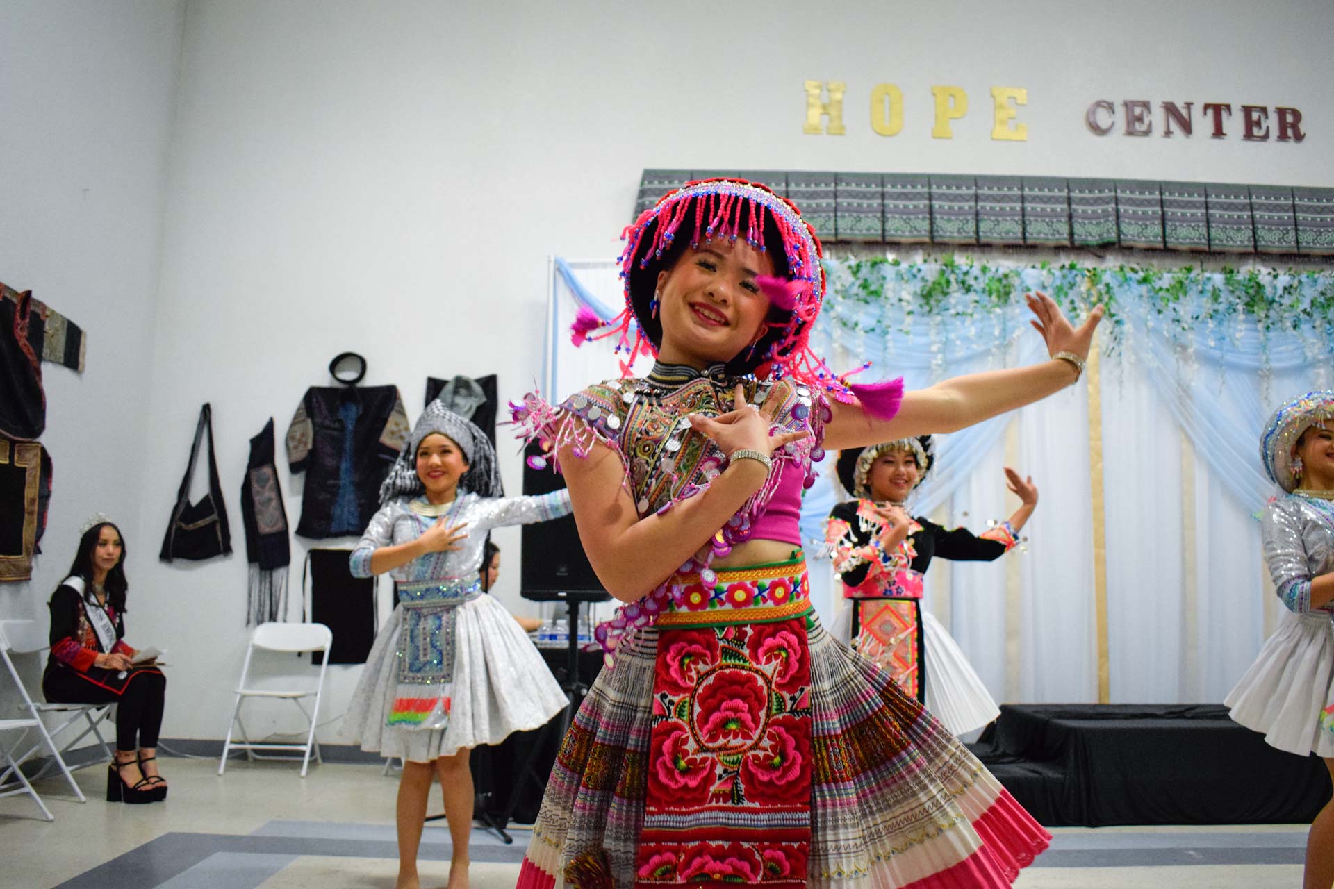 student in traditional Hmong dress dancing