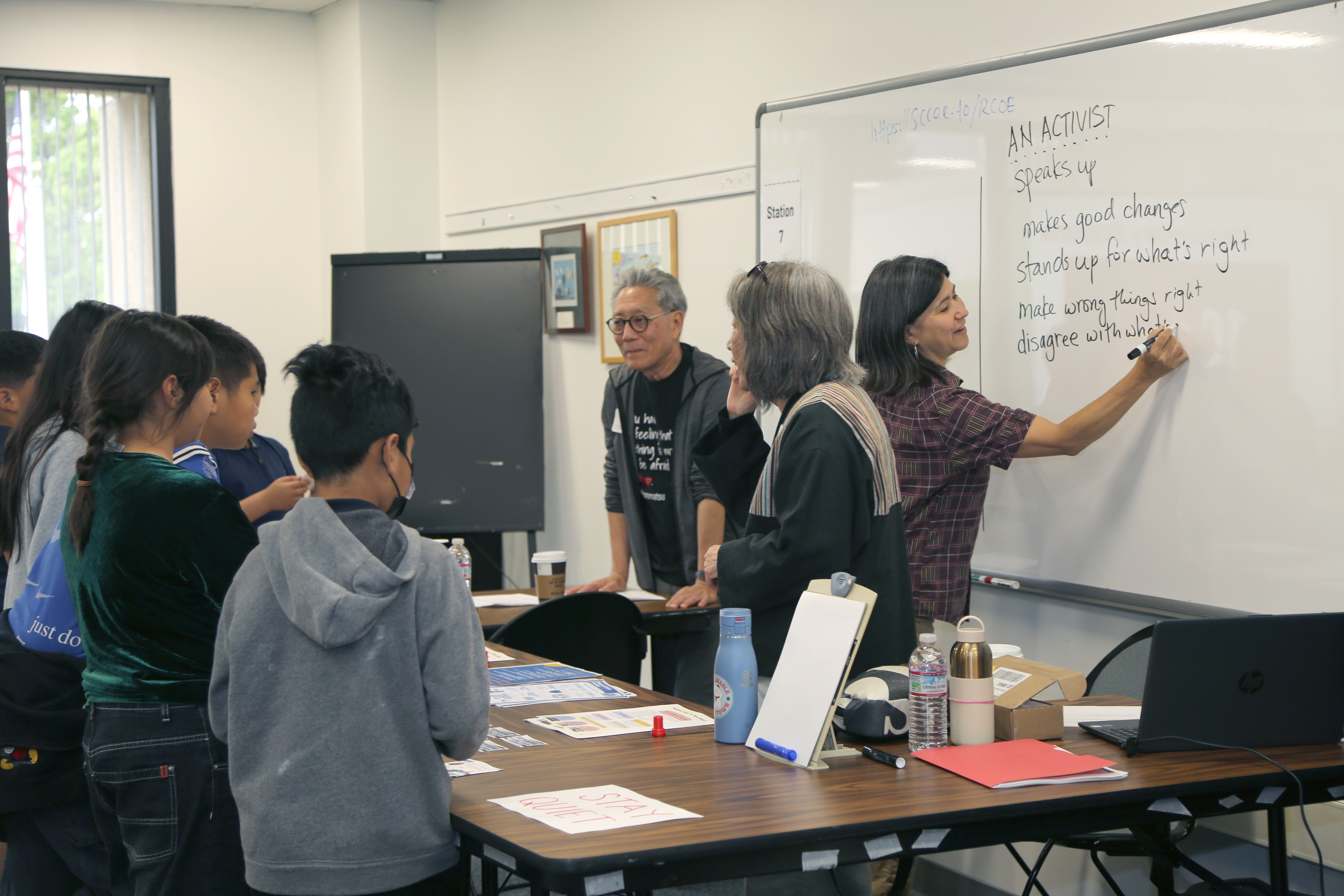 elementary school students engaging in an activity about activism with partners