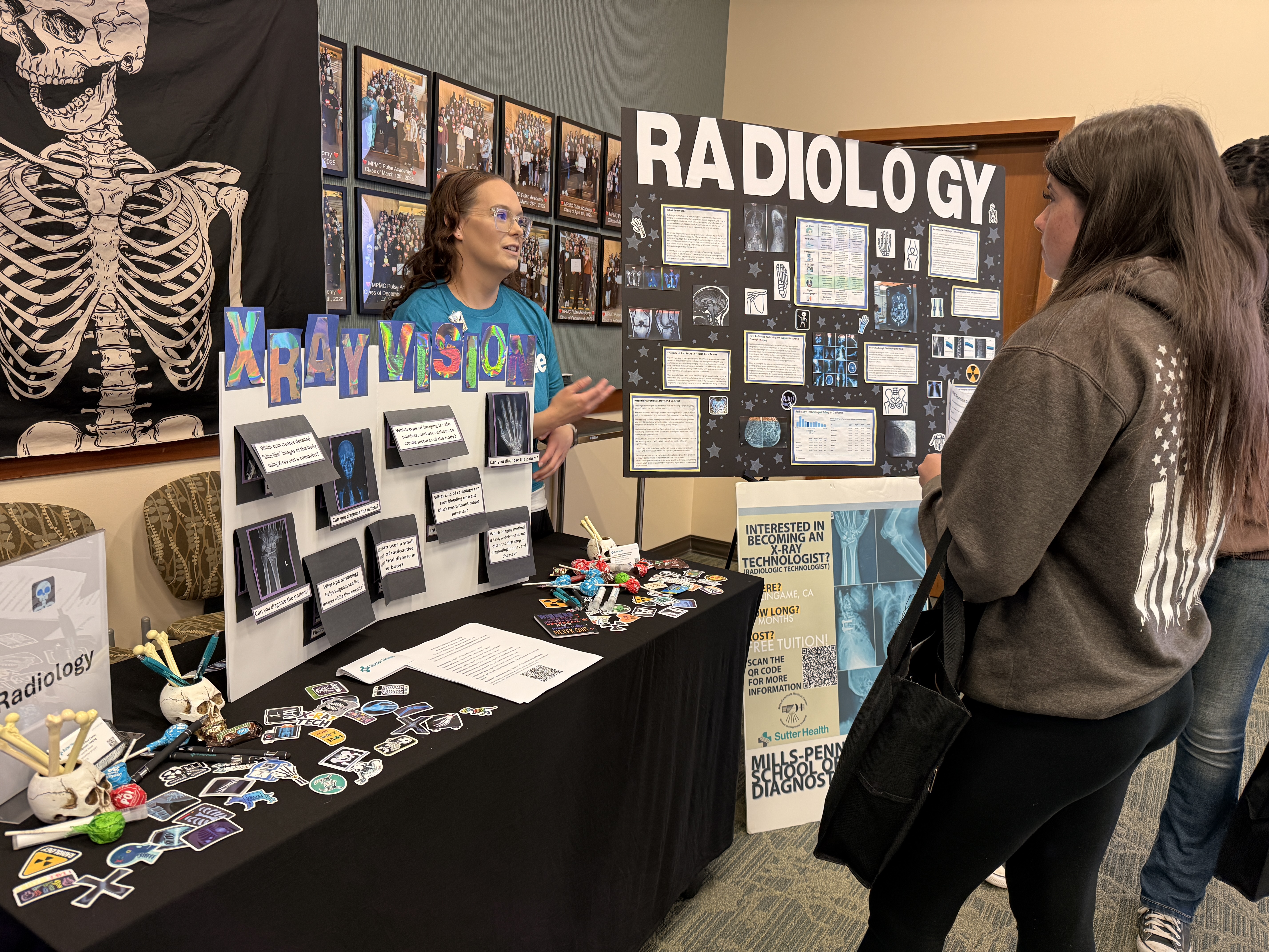 Student engaging with Radiology table and representative to learn more about this career path