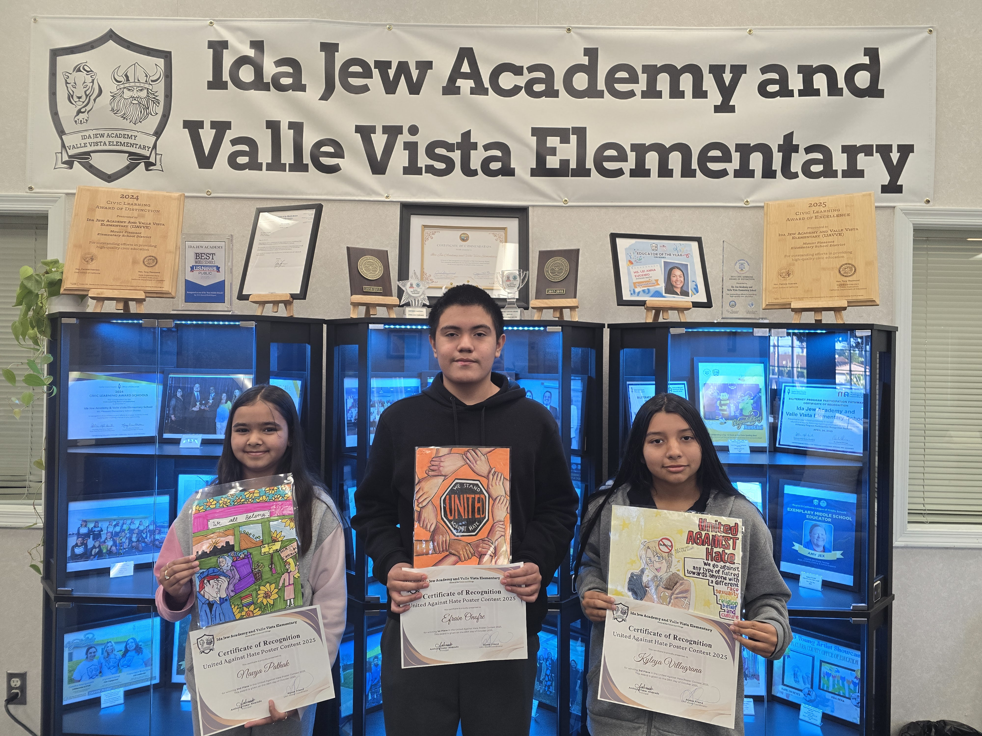 Three Students from Ida Jew Academy and Valle Vista Elementary displaying their United Against Hate-Inspired Art