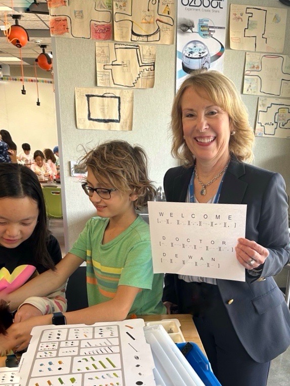 Dr. Dewan with student's weclome message in braille