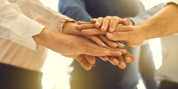team hands on top of each other
