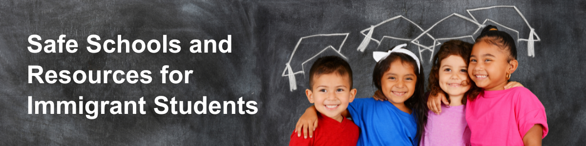 Four elementary school students in front of chalkboard with outline of graduation caps